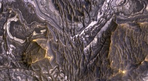 This view shows color variations in bright layered deposits on a plateau near Juventae Chasma in the Valles Marineris region of Mars. Image credit: NASA/JPL-Caltech/University of Arizona This view shows color variations in bright layered deposits on a plateau near Juventae Chasma in the Valles Marineris region of Mars. Image credit: NASA/JPL-Caltech/University of Arizona