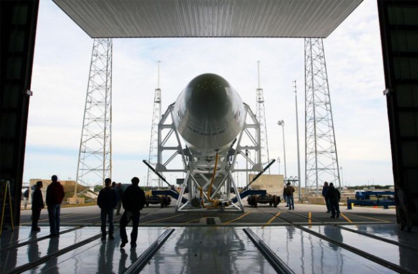 The full flight-ready Falcon 9 with Dragon qualification spacecraft rolls out of the SpaceX hangar at SLC-40, Cape Canaveral, Florida. Credit: SpaceX. The full flight-ready Falcon 9 with Dragon qualification spacecraft rolls out of the SpaceX hangar at SLC-40, Cape Canaveral, Florida. Credit: SpaceX.