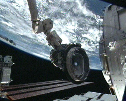 Pressurized Mating Adapter-3 is relocated from the Harmony module to the open port on the end of the Tranquility node. Image credit: NASA TV Pressurized Mating Adapter-3 is relocated from the Harmony module to the open port on the end of the Tranquility node. Image credit: NASA TV