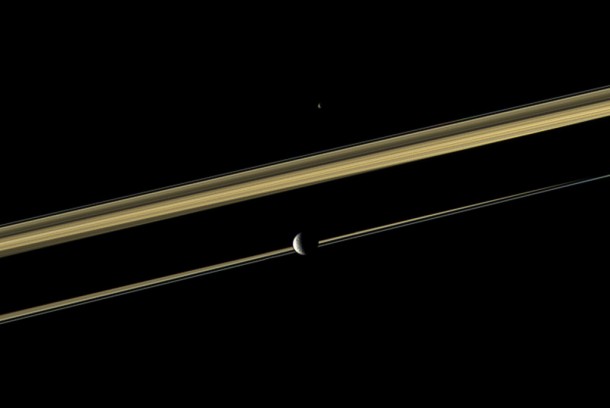Two of Saturn's moons straddle the planet's rings in this color view. Credit: NASA Two of Saturn's moons straddle the planet's rings in this color view. Credit: NASA