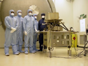 Scientists and Engineers in a clean room at the Science and Technology Facilities Council’s Rutherford Appleton Laboratory with the model of the MIRI instrument. Credit: Science and Technology Facilities Council (STFC) Scientists and Engineers in a clean room at the Science and Technology Facilities Council’s Rutherford Appleton Laboratory with the model of the MIRI instrument. Credit: Science and Technology Facilities Council (STFC)