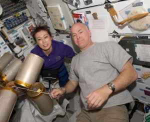 STS-131 Commander Alan Poindexter and Mission Specialist Naoko Yamazaki work with lithium hydroxide (LiOH) canisters on space shuttle Discovery's middeck while docked with the International Space Station. Image credit: NASA STS-131 Commander Alan Poindexter and Mission Specialist Naoko Yamazaki work with lithium hydroxide (LiOH) canisters on space shuttle Discovery's middeck while docked with the International Space Station. Image credit: NASA