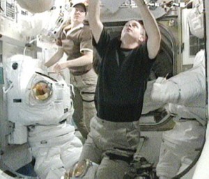 Flight Engineers T.J. Creamer (foreground) and Tracy Caldwell Dyson were in the U.S. Quest airlock Thursday resizing spacesuits for the upcoming STS-132 mission. Credit: NASA TV Flight Engineers T.J. Creamer (foreground) and Tracy Caldwell Dyson were in the U.S. Quest airlock Thursday resizing spacesuits for the upcoming STS-132 mission. Credit: NASA TV