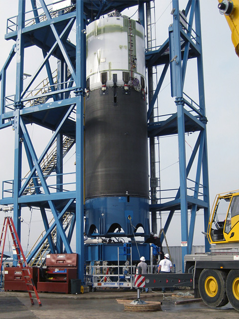 Installing the Falcon 9 Flight 2 second stage tank structure (white cylinder, top) and test interstage (black cylinder, center) into the structural test stand at our Texas Test Facility. Subsequently, we filled the stage with cryogenic nitrogen, then pressurized and tested it under a variety of load conditions, qualifying it for flight. Credit: SpaceX. Installing the Falcon 9 Flight 2 second stage tank structure (white cylinder, top) and test interstage (black cylinder, center) into the structural test stand at our Texas Test Facility. Subsequently, we filled the stage with cryogenic nitrogen, then pressurized and tested it under a variety of load conditions, qualifying it for flight. Credit: SpaceX.