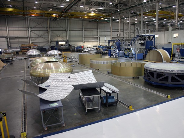 Hardware for the third Falcon 9 flight in process in our Hawthorne factory, including first and second stage domes, barrel segments, and Dragon capsule pressure vessel walls. Credit: SpaceX. Hardware for the third Falcon 9 flight in process in our Hawthorne factory, including first and second stage domes, barrel segments, and Dragon capsule pressure vessel walls. Credit: SpaceX.