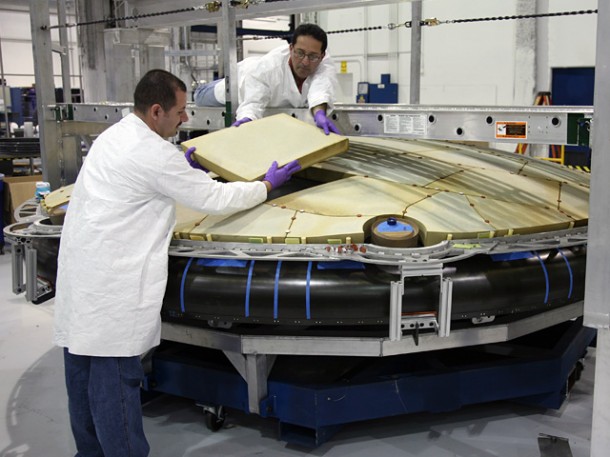 Test placement of the flight PICA-X tiles on the first flight Dragon heat shield carrier structure. During reentry the lightweight tiles withstand temperatures as high as 2000 degrees Celsius (3620 degrees F). Credit: SpaceX / Roger Gilbertson. Test placement of the flight PICA-X tiles on the first flight Dragon heat shield carrier structure. During reentry the lightweight tiles withstand temperatures as high as 2000 degrees Celsius (3620 degrees F). Credit: SpaceX / Roger Gilbertson.