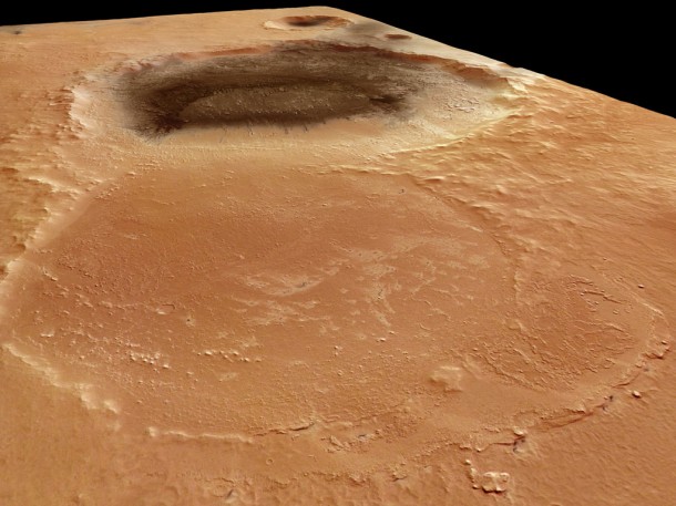 Three craters stretch across the Meridiani Planum region of Mars. The nearest is an old crater, almost worn away. It is 34 km across. The second is covered in dark material, most likely a substance resembling volcanic ash. Credits: ESA/DLR/FU Berlin (G. Neukum) Three craters stretch across the Meridiani Planum region of Mars. The nearest is an old crater, almost worn away. It is 34 km across. The second is covered in dark material, most likely a substance resembling volcanic ash. Credits: ESA/DLR/FU Berlin (G. Neukum)