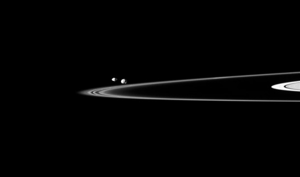 Two of Saturn's small moons can be seen orbiting beyond the planet's thin F ring in this Cassini spacecraft image. Credit: NASA/JPL/Space Science Institute Two of Saturn's small moons can be seen orbiting beyond the planet's thin F ring in this Cassini spacecraft image. Credit: NASA/JPL/Space Science Institute