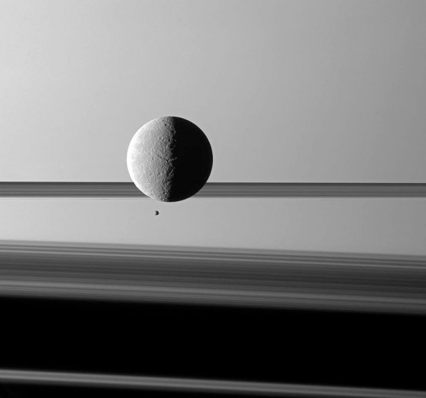 Saturn's moon Rhea looms "over" a smaller and more distant Epimetheus against a striking background of planet and rings. Credit: NASA/JPL/Space Science Institute Saturn's moon Rhea looms "over" a smaller and more distant Epimetheus against a striking background of planet and rings. Credit: NASA/JPL/Space Science Institute