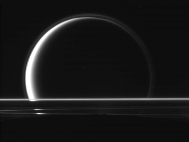 This raw, unprocessed image of Titan behind Saturn's rings was taken on May 18, 2010, by the Cassini spacecraft. The dark curve of Enceladus is visible at the bottom of the image. Credit: NASA/JPL/SSI This raw, unprocessed image of Titan behind Saturn's rings was taken on May 18, 2010, by the Cassini spacecraft. The dark curve of Enceladus is visible at the bottom of the image. Credit: NASA/JPL/SSI