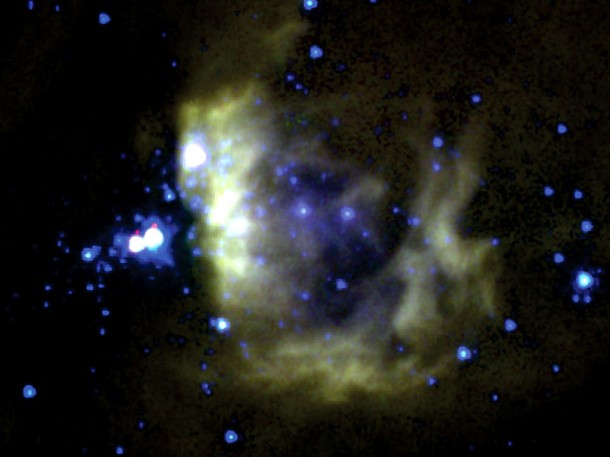 This is a mid-infrared image of a giant cloud obtained by NASA’s Spitzer Space Telescope. The yellowish wisps to the right are remnants of gas that have been heated and are being driven off by the massive young stars within them, seen in blue. Credit: NASA/JPL-Caltech This is a mid-infrared image of a giant cloud obtained by NASA’s Spitzer Space Telescope. The yellowish wisps to the right are remnants of gas that have been heated and are being driven off by the massive young stars within them, seen in blue. Credit: NASA/JPL-Caltech