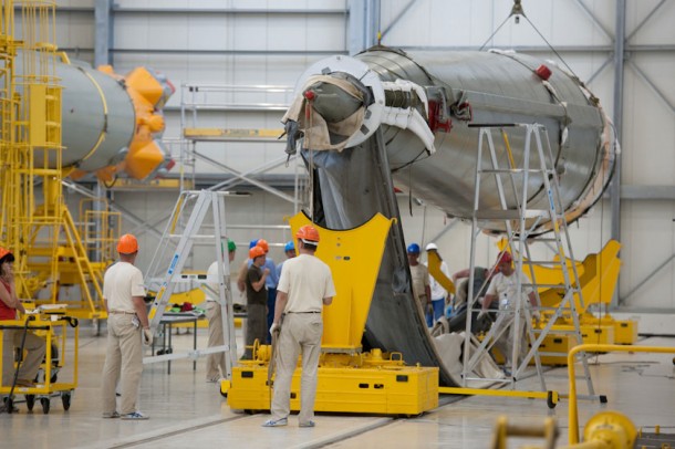 This head-on view highlights the tapered/cylinder shape of the Soyuz first stage booster. Its oxidizer tank is carried in the tapered portion, and the kerosene tank installed in the cylindrical section. Each booster is powered by an RD-107A engine which operates on liquid oxygen and kerosene – the same propellants used on each of the Soyuz’ three main stages. The booster’s RD-107A engine has four combustion chambers and nozzles. This head-on view highlights the tapered/cylinder shape of the Soyuz first stage booster. Its oxidizer tank is carried in the tapered portion, and the kerosene tank installed in the cylindrical section. Each booster is powered by an RD-107A engine which operates on liquid oxygen and kerosene – the same propellants used on each of the Soyuz’ three main stages. The booster’s RD-107A engine has four combustion chambers and nozzles.