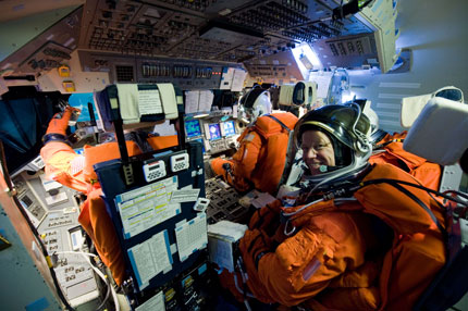 Astronaut Tim Kopra sits in the flight engineer's position during a simulation earlier this year for the STS-133 mission. Commander Steve Lindsey is sitting in the left-hand seat in the front of the flight deck mockup as Pilot Eric Boe works in the right seat. Misison Specialist Alvin Drew is sitting beside Kopra. Image Credit: NASA Astronaut Tim Kopra sits in the flight engineer's position during a simulation earlier this year for the STS-133 mission. Commander Steve Lindsey is sitting in the left-hand seat in the front of the flight deck mockup as Pilot Eric Boe works in the right seat. Misison Specialist Alvin Drew is sitting beside Kopra. Image Credit: NASA