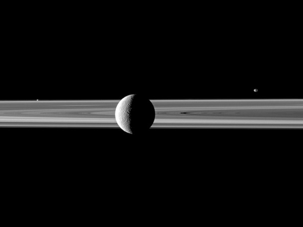 A pair of small moons join Saturn's second largest moon in this Cassini spacecraft image spotlighting Rhea in front of the rings. Credit: NASA/JPL/Space Science Institute A pair of small moons join Saturn's second largest moon in this Cassini spacecraft image spotlighting Rhea in front of the rings. Credit: NASA/JPL/Space Science Institute