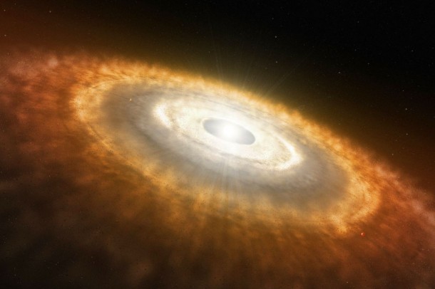 Like a raindrop forming in a cloud, a star forms in a diffuse gas cloud in deep space. As the star grows, its gravitational pull draws in dust and gas from the surrounding molecular cloud to form a swirling disk called a "protoplanetary disk." This disk eventually further consolidates to form planets, moons, asteroids and comets. (Credit: NASA/JPL-Caltech) Like a raindrop forming in a cloud, a star forms in a diffuse gas cloud in deep space. As the star grows, its gravitational pull draws in dust and gas from the surrounding molecular cloud to form a swirling disk called a "protoplanetary disk." This disk eventually further consolidates to form planets, moons, asteroids and comets. (Credit: NASA/JPL-Caltech)