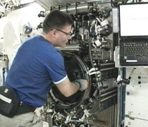 Flight Engineer Doug Wheelock positions the Combustion Integrated Rack back inside the Destiny laboratory’s Fluids and Combustion facility. Credit: NASA TV Flight Engineer Doug Wheelock positions the Combustion Integrated Rack back inside the Destiny laboratory’s Fluids and Combustion facility. Credit: NASA TV