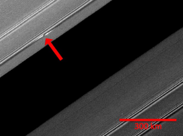 A propeller-shaped structure created by an unseen moon is brightly illuminated on the sunlit side of Saturn's rings in this image obtained by NASA’s Cassini spacecraft. Image Credit: NASA/JPL/SSI A propeller-shaped structure created by an unseen moon is brightly illuminated on the sunlit side of Saturn's rings in this image obtained by NASA’s Cassini spacecraft. Image Credit: NASA/JPL/SSI