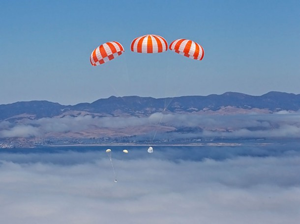 Two released drogue parachutes also visible as the Dragon spacecraft continues its descent. Photo Credit: Chris Thompson/SpaceX. Two released drogue parachutes also visible as the Dragon spacecraft continues its descent. Photo Credit: Chris Thompson/SpaceX.