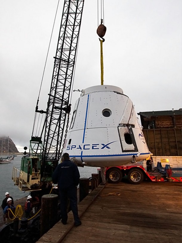 Dragon spacecraft being lifted out the bay and onto its transport carrier for return to SpaceX’s Hawthorne headquarters. Photo Credit: Chris Thompson/SpaceX. Dragon spacecraft being lifted out the bay and onto its transport carrier for return to SpaceX’s Hawthorne headquarters. Photo Credit: Chris Thompson/SpaceX.