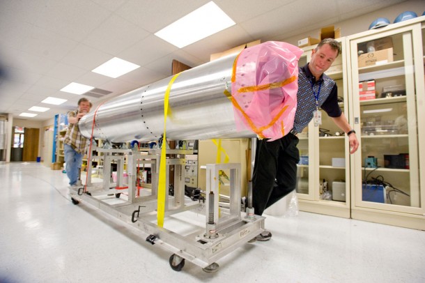 Ed West and Jonathan Cirtain wheel SUMI to the loading dock for shipment to White Sands Missile Range, N.M. (NASA/MSFC/D. Higginbotham) Ed West and Jonathan Cirtain wheel SUMI to the loading dock for shipment to White Sands Missile Range, N.M. (NASA/MSFC/D. Higginbotham)