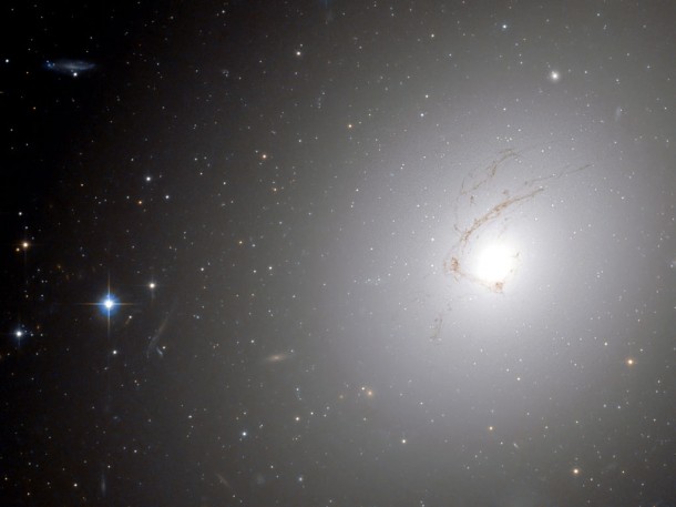 The huge dust lane, around 30 000 light-years across, that sweeps across the face of the galaxy makes NGC 4696 look different from most other elliptical galaxies. Credit: ESA/Hubble and NASA The huge dust lane, around 30 000 light-years across, that sweeps across the face of the galaxy makes NGC 4696 look different from most other elliptical galaxies. Credit: ESA/Hubble and NASA
