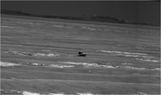 NASA's Mars Exploration Rover Opportunity used its panoramic camera to capture this view of a dark rock that may be an iron meteorite. Part of the rim of Endurance Crater is on the horizon. Image Credit: NASA/JPL-Caltech/Cornell University NASA's Mars Exploration Rover Opportunity used its panoramic camera to capture this view of a dark rock that may be an iron meteorite. Part of the rim of Endurance Crater is on the horizon. Image Credit: NASA/JPL-Caltech/Cornell University
