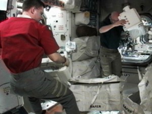 Expedition 25 Commander Doug Wheelock (left) and Flight Engineer Scott Kelly prepare the Simplified Aid for EVA Rescue backpacks for use during the STS-133 space shuttle mission. Credit: NASA TV Expedition 25 Commander Doug Wheelock (left) and Flight Engineer Scott Kelly prepare the Simplified Aid for EVA Rescue backpacks for use during the STS-133 space shuttle mission. Credit: NASA TV