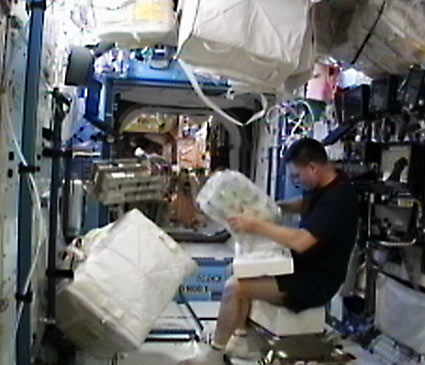 Commander Doug Wheelock unpacks gear for the Sabatier life support system inside the U.S. Destiny laboratory. Credit: NASA TV Commander Doug Wheelock unpacks gear for the Sabatier life support system inside the U.S. Destiny laboratory. Credit: NASA TV