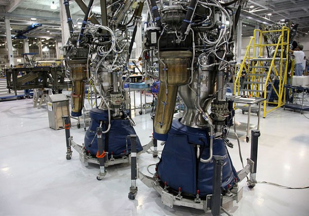 Recently returned from acceptance test firing in Texas, two Merlin engines for Falcon 9 Flight 3 await integration into the first stage thrust structure at far left, while a Merlin destined for Flight 4 nears completion at far right. Photo: SpaceX. Recently returned from acceptance test firing in Texas, two Merlin engines for Falcon 9 Flight 3 await integration into the first stage thrust structure at far left, while a Merlin destined for Flight 4 nears completion at far right. Photo: SpaceX.