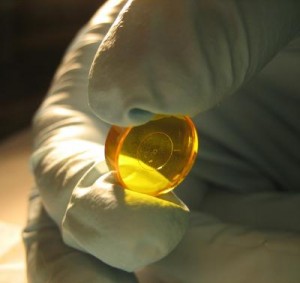 Similar in size and shape to a cough drop, the Apodizing Phase Plate causes light waves coming from a star to interfere with each other, exposing the faint glow of a nearby planet. Shown here is an early version. Credit: University of Arizona Similar in size and shape to a cough drop, the Apodizing Phase Plate causes light waves coming from a star to interfere with each other, exposing the faint glow of a nearby planet. Shown here is an early version. Credit: University of Arizona