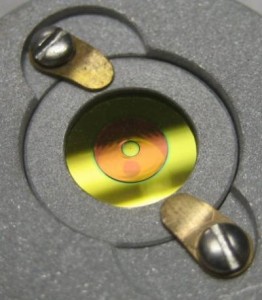 The Apodizing Phase Plate is manufactured in a process called diamond turning. In a phonograph’s fashion, a diamond bit engraves grooves at precisely calculated positions into a rotating glass blank. The resulting optic shows only a subtle effect to the eye, but has a big effect on the starlight halo. Shown here is an earlier version now in use at the an observatory on Mount Hopkins, Ariz. Credit: University of Arizona The Apodizing Phase Plate is manufactured in a process called diamond turning. In a phonograph’s fashion, a diamond bit engraves grooves at precisely calculated positions into a rotating glass blank. The resulting optic shows only a subtle effect to the eye, but has a big effect on the starlight halo. Shown here is an earlier version now in use at the an observatory on Mount Hopkins, Ariz. Credit: University of Arizona