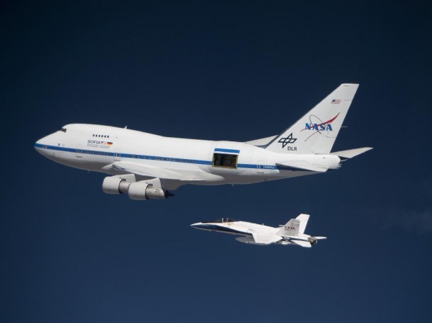 In stark contrast with the deep blue sky at high altitude, NASA’s Stratospheric Observatory for Infrared Astronomy 747SP checks out operation of its telescope cavity doors while a NASA F/A-18 mission support aircraft keeps pace alongside during a test flight. Credit: NASA / Jim Ross In stark contrast with the deep blue sky at high altitude, NASA’s Stratospheric Observatory for Infrared Astronomy 747SP checks out operation of its telescope cavity doors while a NASA F/A-18 mission support aircraft keeps pace alongside during a test flight. Credit: NASA / Jim Ross