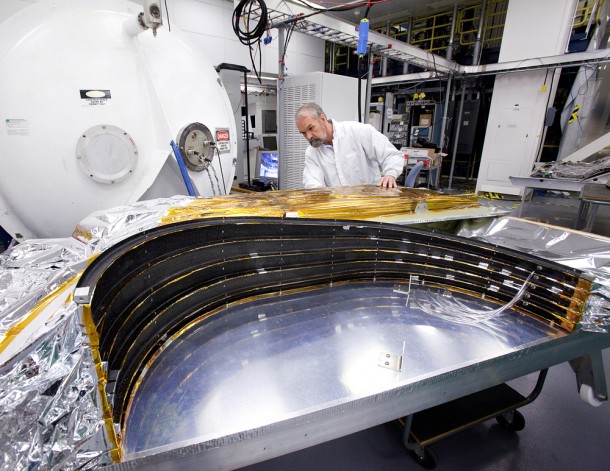 Northrop Grumman Lead Venting Analyst Dan McGregor inspects a sunshield test article for the sunshield section on top of the spacecraft around the tower that supports the telescope. Credit: Northrop Grumman Aerospace Systems. Northrop Grumman Lead Venting Analyst Dan McGregor inspects a sunshield test article for the sunshield section on top of the spacecraft around the tower that supports the telescope. Credit: Northrop Grumman Aerospace Systems.