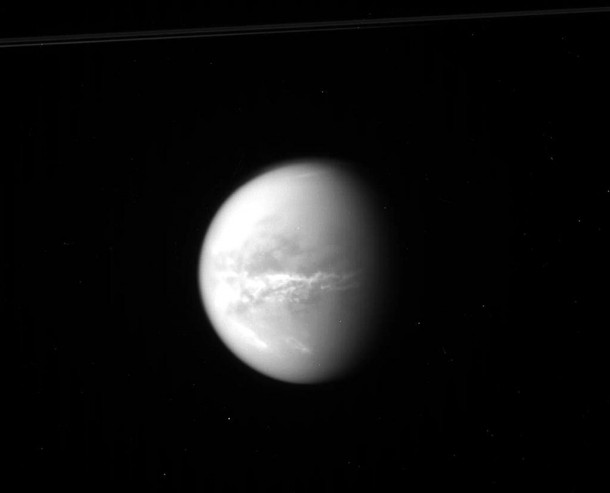 NASA's Cassini spacecraft obtained this raw image of Saturn's moon Titan on Oct. 18, 2010. Bright clouds streak the moon's midsection, likely an indication of changing seasons and the arrival of spring in the northern hemisphere. Credit: NASA/JPL/SSI NASA's Cassini spacecraft obtained this raw image of Saturn's moon Titan on Oct. 18, 2010. Bright clouds streak the moon's midsection, likely an indication of changing seasons and the arrival of spring in the northern hemisphere. Credit: NASA/JPL/SSI