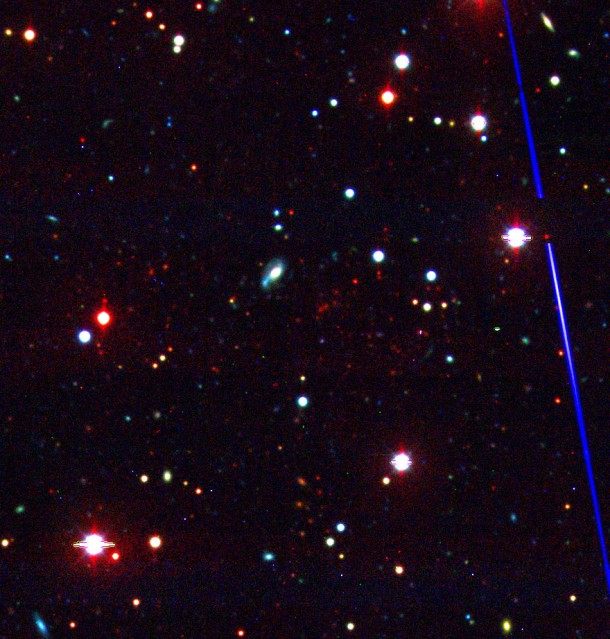 This optical image of the newfound galaxy cluster highlights how faint and reddened these galaxies are due to their great distance. The cluster remained hidden until the South Pole Telescope spotted it by looking for distortions in the cosmic microwave background. Credit: CTIO Blanco 4-m telescope/J. Mohr (LMU Munich) This optical image of the newfound galaxy cluster highlights how faint and reddened these galaxies are due to their great distance. The cluster remained hidden until the South Pole Telescope spotted it by looking for distortions in the cosmic microwave background. Credit: CTIO Blanco 4-m telescope/J. Mohr (LMU Munich)