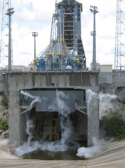 Liquid oxygen is shown venting from the Soyuz launch pad during validation tests performed with this propellant in September and October. The liquid oxygen will be used along with kerosene to power the Soyuz’ three primary stages. This view shows the launch pad as seen from the massive concrete flame trench, which was excavated into layers of soil and granite at the Spaceport. Liquid oxygen is shown venting from the Soyuz launch pad during validation tests performed with this propellant in September and October. The liquid oxygen will be used along with kerosene to power the Soyuz’ three primary stages. This view shows the launch pad as seen from the massive concrete flame trench, which was excavated into layers of soil and granite at the Spaceport.