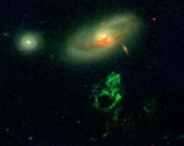 The green Voorwerp in the foreground remains illuminated by light emitted up to 70,000 years ago by a quasar in the center of the background galaxy, which has since died out. Credit: WIYN/William Keel/Anna Manning The green Voorwerp in the foreground remains illuminated by light emitted up to 70,000 years ago by a quasar in the center of the background galaxy, which has since died out. Credit: WIYN/William Keel/Anna Manning