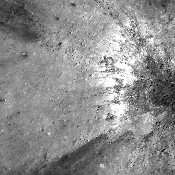 Materials of different reflectance are exposed by a 350 m diameter fresh impact crater near the southern rim of Menelaus crater. The western wall of this small impact crater appears to be composed primarily of very high reflectance material. Image width is 400 m, LROC NAC M126826332R, illumination is from the right. Credit: NASA/GSFC/Arizona State University Materials of different reflectance are exposed by a 350 m diameter fresh impact crater near the southern rim of Menelaus crater. The western wall of this small impact crater appears to be composed primarily of very high reflectance material. Image width is 400 m, LROC NAC M126826332R, illumination is from the right. Credit: NASA/GSFC/Arizona State University