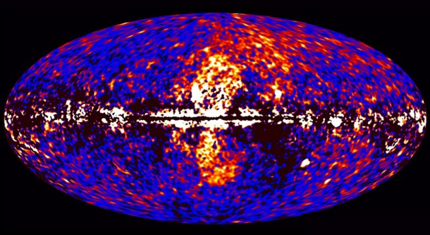 A giant gamma-ray structure was discovered by processing Fermi all-sky data at energies from 1 to 10 billion electron volts, shown here. The dumbbell-shaped feature (center) emerges from the galactic center and extends 50 degrees north and south from the plane of the Milky Way, spanning the sky from the constellation Virgo to the constellation Grus. Credit: NASA/DOE/Fermi LAT/D. Finkbeiner et al. A giant gamma-ray structure was discovered by processing Fermi all-sky data at energies from 1 to 10 billion electron volts, shown here. The dumbbell-shaped feature (center) emerges from the galactic center and extends 50 degrees north and south from the plane of the Milky Way, spanning the sky from the constellation Virgo to the constellation Grus. Credit: NASA/DOE/Fermi LAT/D. Finkbeiner et al.