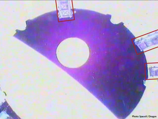 High contrast view of the Dragon spacecraft (circle at center) viewed from the top of the second stage as it departs over the curved horizon of the Earth. The rectangles indicate locations of three of the nano satellite deploying P-PODs carried on this mission. Credit: SpaceX High contrast view of the Dragon spacecraft (circle at center) viewed from the top of the second stage as it departs over the curved horizon of the Earth. The rectangles indicate locations of three of the nano satellite deploying P-PODs carried on this mission. Credit: SpaceX