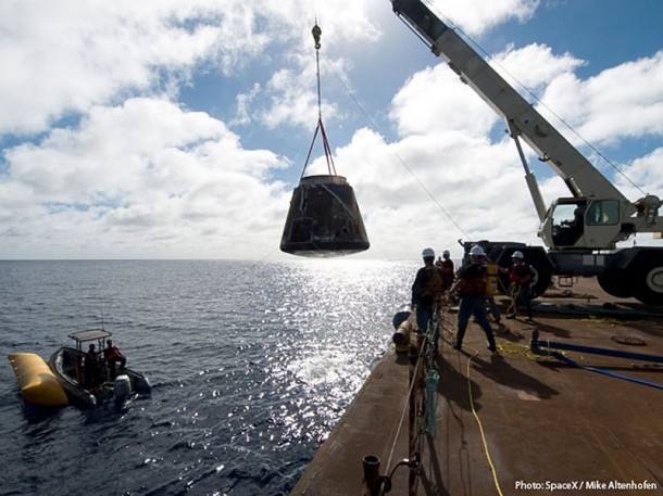 The SpaceX crew brought Dragon back to the barge where the crane lifted it from the water. Credit: SpaceX The SpaceX crew brought Dragon back to the barge where the crane lifted it from the water. Credit: SpaceX