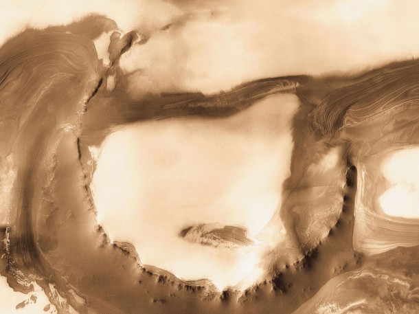 Although it is 45 kilometers (28 miles) wide, countless layers of ice and dust have all but buried Udzha Crater. Image credit: NASA/JPL-Caltech/ASU Although it is 45 kilometers (28 miles) wide, countless layers of ice and dust have all but buried Udzha Crater. Image credit: NASA/JPL-Caltech/ASU