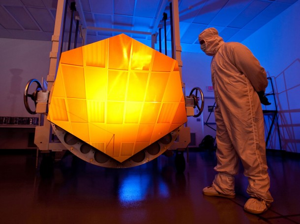 The James Webb Space Telescope's Engineering Design Unit (EDU) primary mirror segment, coated with gold by Quantum Coating Incorporated. The actuator is located behind the mirror. Credit: Drew Noel The James Webb Space Telescope's Engineering Design Unit (EDU) primary mirror segment, coated with gold by Quantum Coating Incorporated. The actuator is located behind the mirror. Credit: Drew Noel