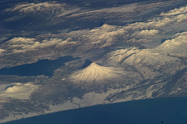 This striking photograph features several snow-covered volcanoes located on the Kamchatka Peninsula of the Russian Federation, as seen from the orbital perspective of the International Space Station (ISS). Credit: NASA This striking photograph features several snow-covered volcanoes located on the Kamchatka Peninsula of the Russian Federation, as seen from the orbital perspective of the International Space Station (ISS). Credit: NASA