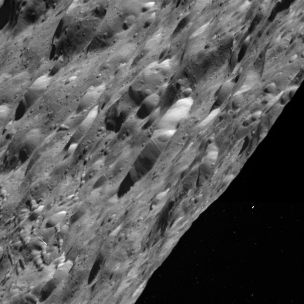 This raw image obtained by NASA's Cassini spacecraft of Saturn's moon Rhea shows craters in an area between day and night on the icy moon. The bright spot to the right is likely a cosmic ray hit.Image credit: NASA/JPL/SSI This raw image obtained by NASA's Cassini spacecraft of Saturn's moon Rhea shows craters in an area between day and night on the icy moon. The bright spot to the right is likely a cosmic ray hit.Image credit: NASA/JPL/SSI