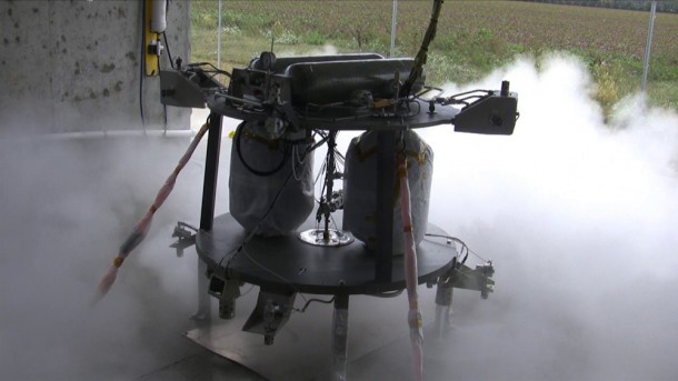 The robotic lander prototype's propulsion system, shown during a hot-fire test, consists of 12 small attitude control thrusters, three primary descent thrusters to control the vehicle’s altitude, and one large “gravity-canceling” thruster which offsets a portion of the prototype’s weight to simulate a lower gravity environment, like that of the moon and asteroids. (Dynetics Corp.) The robotic lander prototype's propulsion system, shown during a hot-fire test, consists of 12 small attitude control thrusters, three primary descent thrusters to control the vehicle’s altitude, and one large “gravity-canceling” thruster which offsets a portion of the prototype’s weight to simulate a lower gravity environment, like that of the moon and asteroids. (Dynetics Corp.)