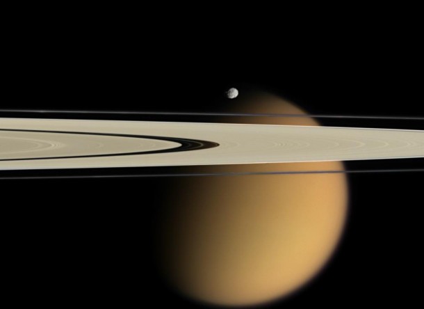 The blurring effects of Titan's aerosols are obvious in this image, where the orange moon peeks from behind two of Saturn's rings. Small, battered Epimetheus, another of Saturn's 62 moons, appears just above the rings. Image credit: NASA/JPL/Space Science Institute The blurring effects of Titan's aerosols are obvious in this image, where the orange moon peeks from behind two of Saturn's rings. Small, battered Epimetheus, another of Saturn's 62 moons, appears just above the rings. Image credit: NASA/JPL/Space Science Institute