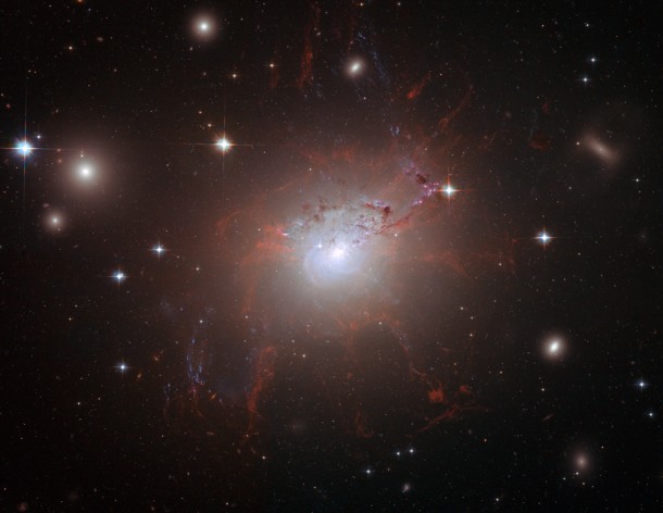 This Hubble Space Telescope image shows NGC 1275, the galaxy located in the center of the Perseus Galaxy Cluster. The red threadlike filaments are composed of cool gas suspended by a magnetic field. (Credit: NASA/ESA/Hubble Heritage (STScI/AURA)-ESA/Hubble Collaboration) This Hubble Space Telescope image shows NGC 1275, the galaxy located in the center of the Perseus Galaxy Cluster. The red threadlike filaments are composed of cool gas suspended by a magnetic field. (Credit: NASA/ESA/Hubble Heritage (STScI/AURA)-ESA/Hubble Collaboration)