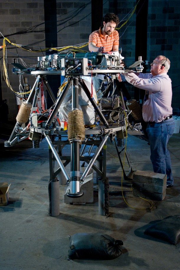 NASA Marshall engineer Josh Moore and Teledyne Brown Engineering avionics engineer Scott Gilley prepare the robotic lander prototype for tests at the U.S. Army Redstone Arsenal Test Center in Huntsville. (NASA/MSFC/David Higginbotham) NASA Marshall engineer Josh Moore and Teledyne Brown Engineering avionics engineer Scott Gilley prepare the robotic lander prototype for tests at the U.S. Army Redstone Arsenal Test Center in Huntsville. (NASA/MSFC/David Higginbotham)
