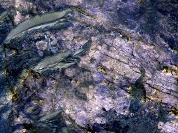 This image from orbit covers an area about 460 meters (about 1,500 feet) across, in which carbonate minerals have been identified from spectrometer observations. Fractures and possible layers are visible in the light-toned rock exposure containing the carbonates. Image Credit: NASA/JPL-Caltech/Univ. of Arizona This image from orbit covers an area about 460 meters (about 1,500 feet) across, in which carbonate minerals have been identified from spectrometer observations. Fractures and possible layers are visible in the light-toned rock exposure containing the carbonates. Image Credit: NASA/JPL-Caltech/Univ. of Arizona